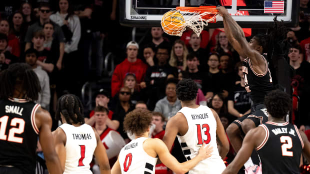 Oklahoma State Cowboys guard Jamyron Keller (14) dunks in the second half of the NCAA basketball game between Cincinnati Bearcats and Oklahoma State Cowboys at Fifth Third Arena in Cincinnati on Wednesday, Feb. 21, 2024.